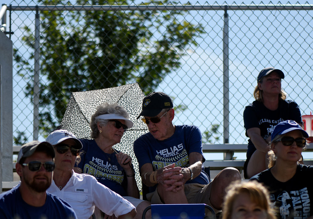 Lynn and Norb Luebbering talk to each other beneath a cheetah-print umbrella